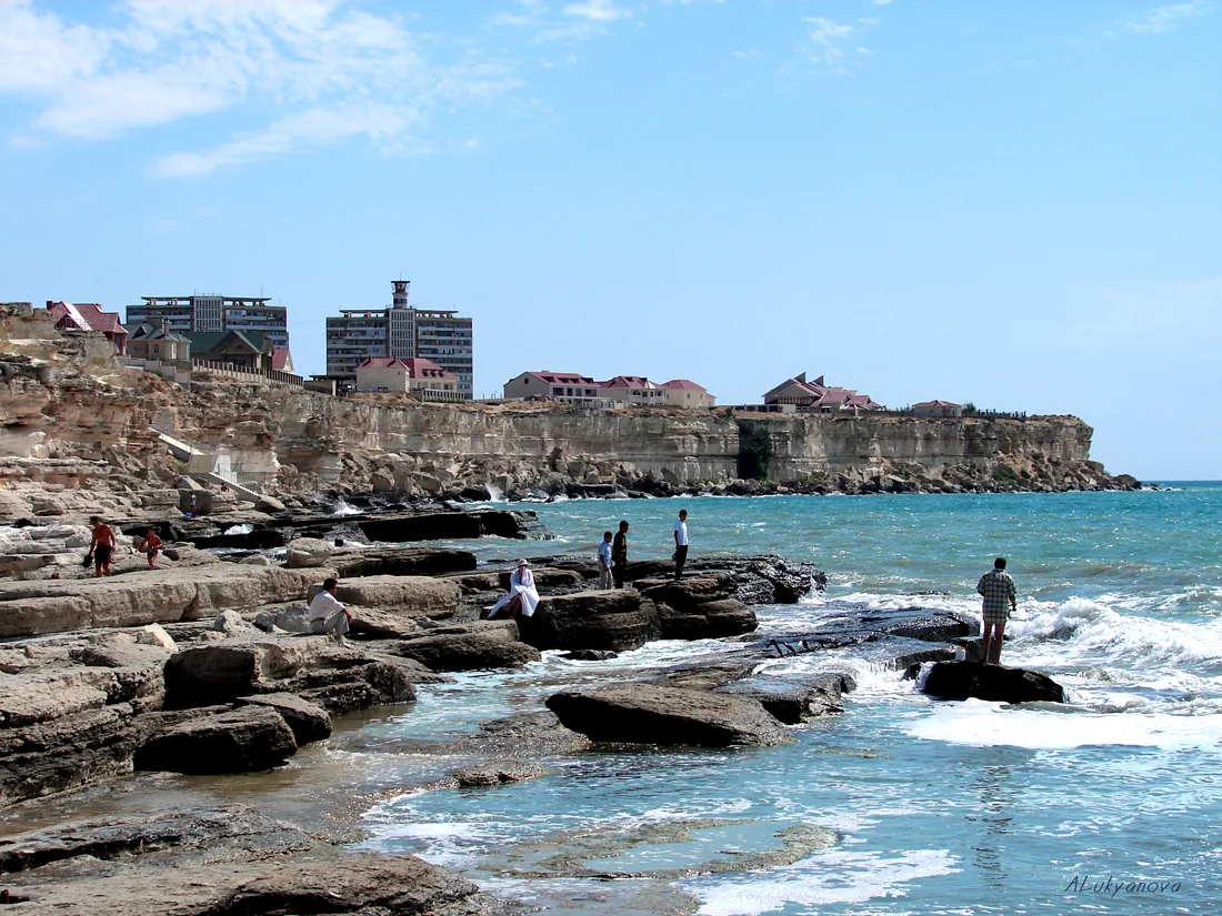A modern coastal city on a low cliff above the Caspian Sea