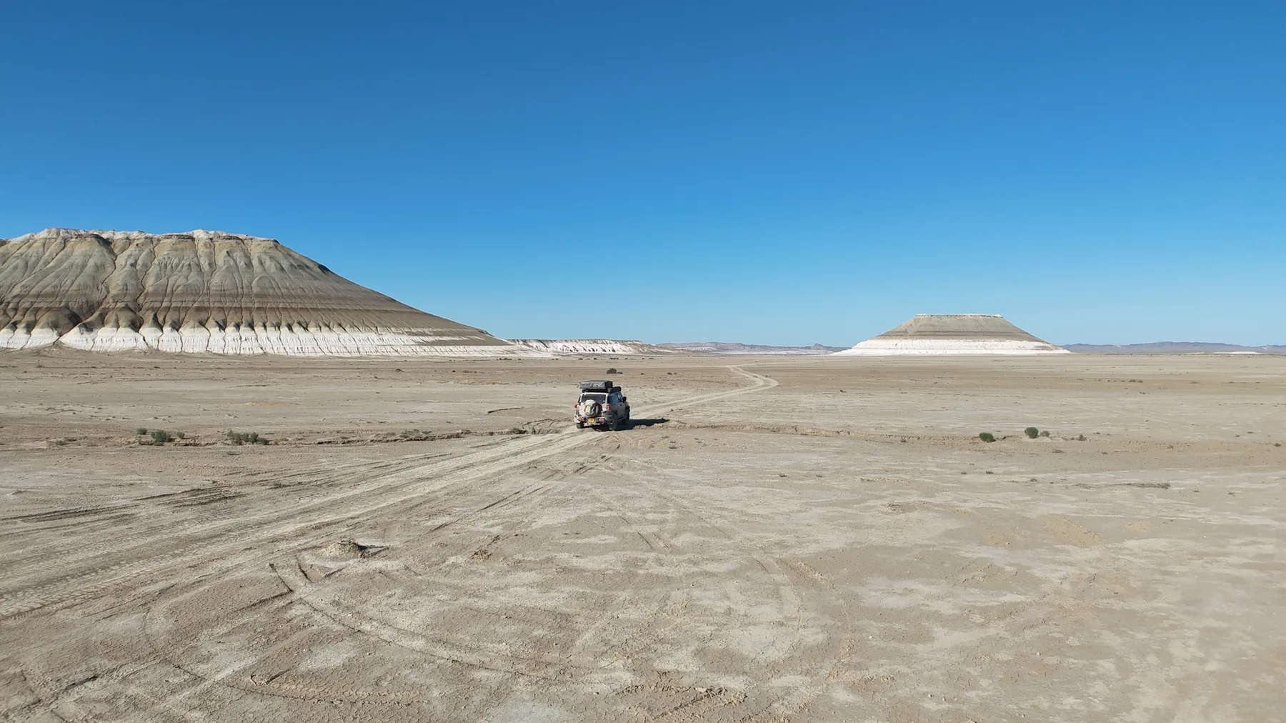 A single dome-topped mountain rising from flat ground, shaped like a resting lion.